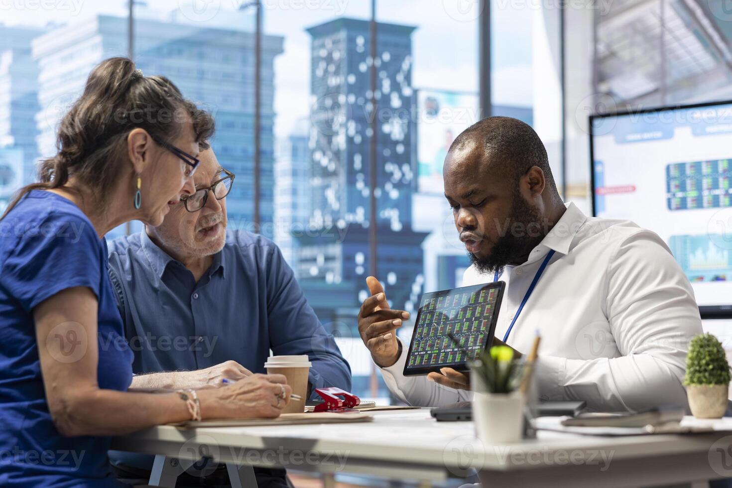 Elderly pair meeting with a financial expert to explore comprehensive retirement strategies, including savings, pension plans and investments. Looking into options to secure finances. photo