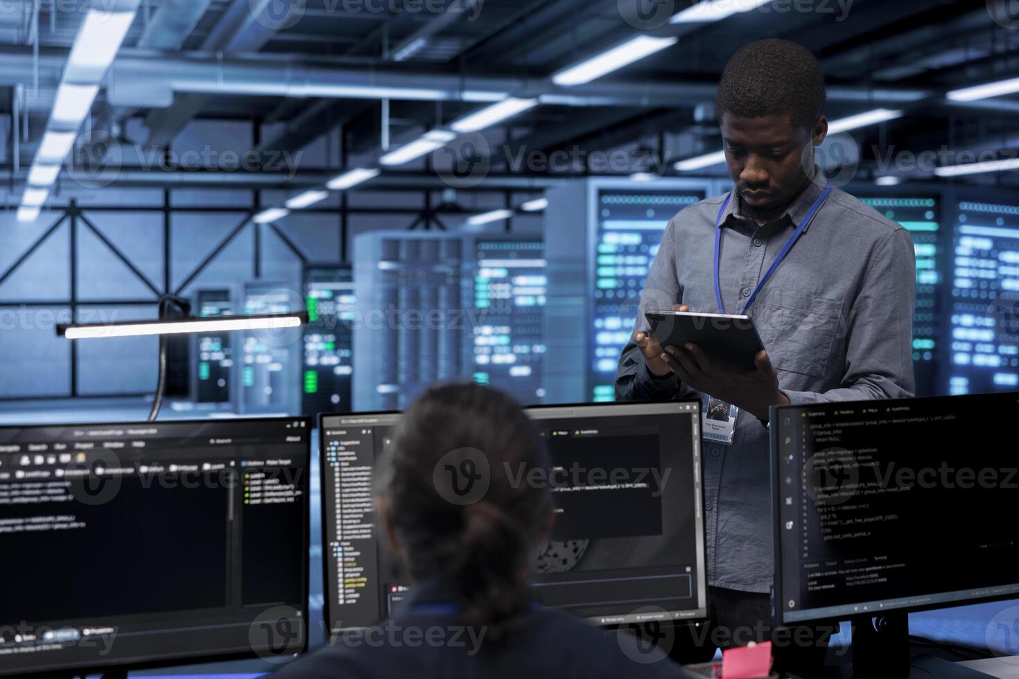 Engineer in data center running system diagnostic tests and error checking utilities to identify and resolve problems. Worker looking for network issues affecting server performance and connectivity photo