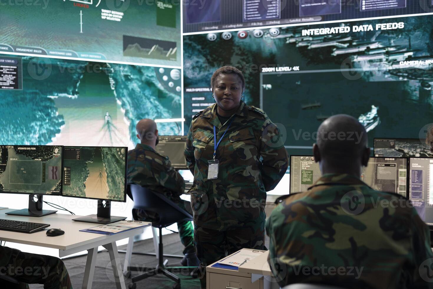 Female intelligence analyst managing the reconnaissance mission with CCTV satellite footage recorded in real time. Woman soldier helping the troops in the field with important enemy intelligence. photo