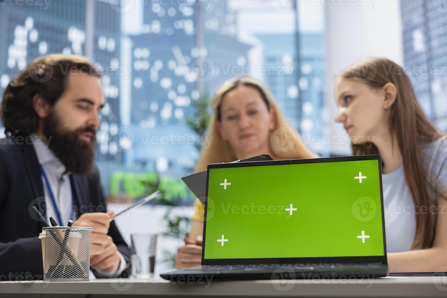 Financial advisor works with clients to create long term investment strategies, using green screen laptop. Agent helps family set realistic financial goals and roadmap using chroma key notebook photo