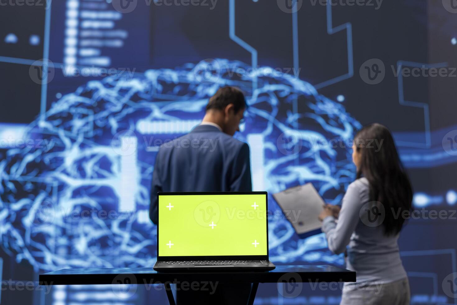 Focus on green screen laptop used by teamworking AI technicians in blurry background using for data analysis. IT experts work on mockup notebook to automatize tasks using artificial intelligence photo
