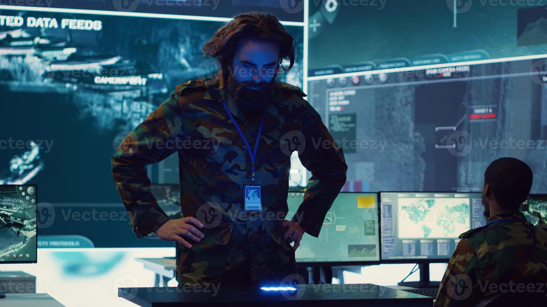 Infantry unit leader studies satellite imagery on a holographic image, working with high tech holograms to create the mission details for the troops. Ways to attack hostile vessels at sea. Camera A. photo