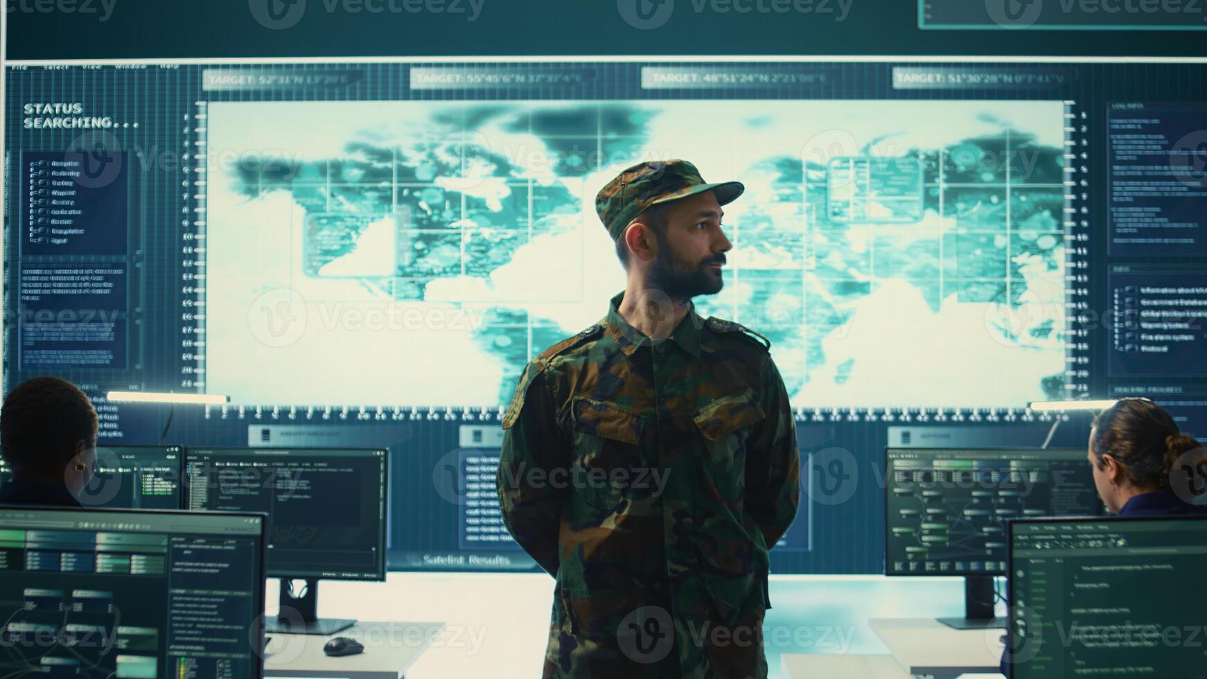 Military IT experts conducting surveillance and espionage activities using advanced technology and big screen. Governmental agency protecting against cyber threats and digital mercenaries. Camera B. photo