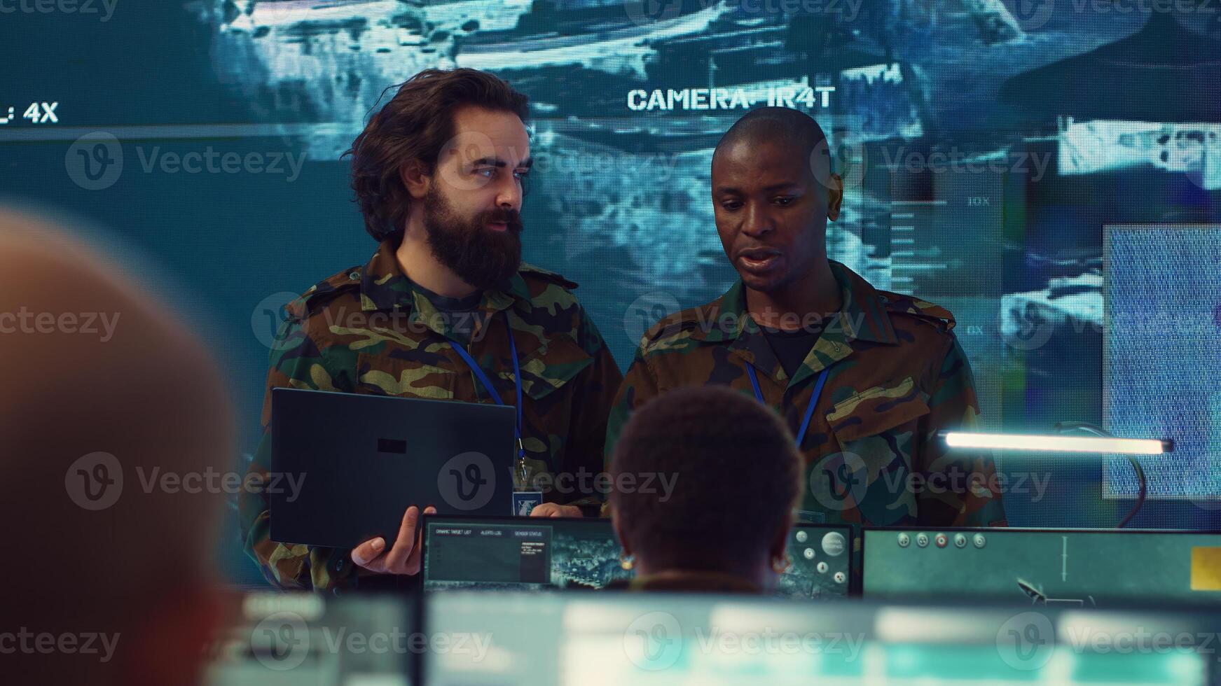 Commanders team conducting briefs to inform and update their troops on mission status and objectives, employing military satellite from a power base of operations. Information gathering. Camera A. photo