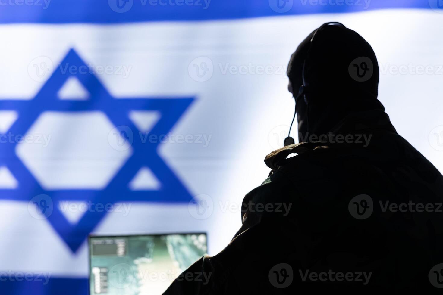 Israeli IDF army conducts tactical reconnaissance, utilizing laptop for data analysis and mission planning, close up. Israel Defense Forces agent looks at aerial map on screen, pinpointing targets photo