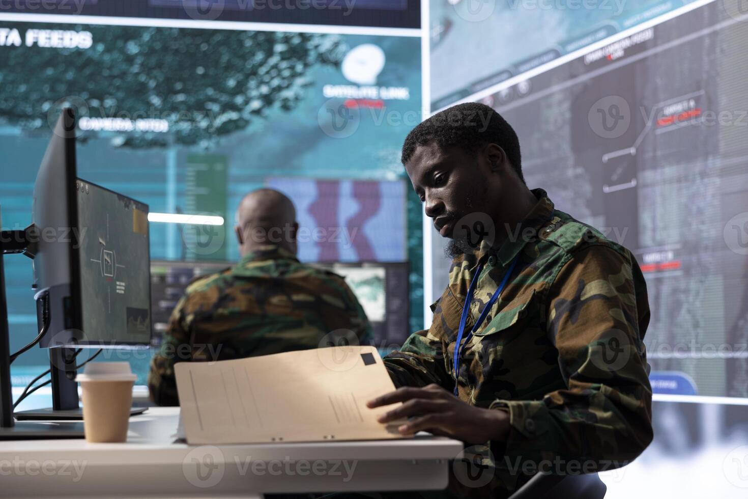 Military man in a command center uses advanced technology and classified documents to support strategic planning, monitoring potential threats. Ensure the success of army troops operations. photo