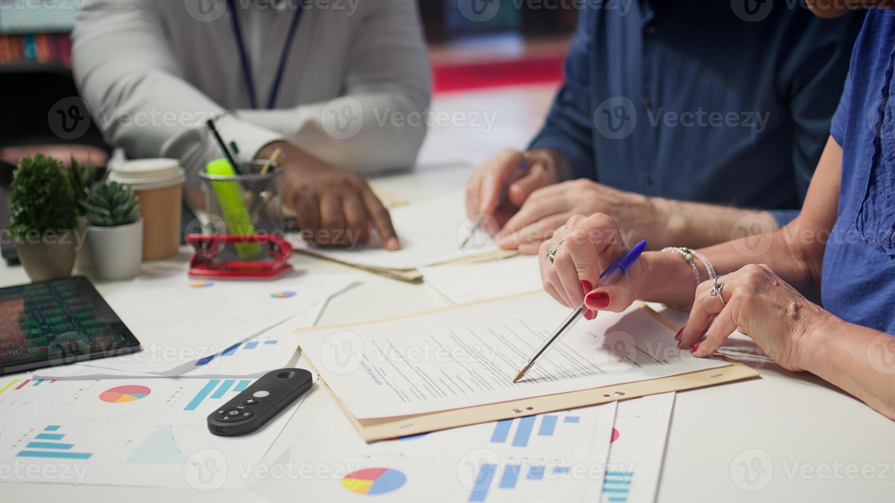 Mature person signing a contract with insurance agency banker, agreeing to the new pension plan contract with expert. Retired man collaborating with advisor to secure his life savings. Camera B. photo