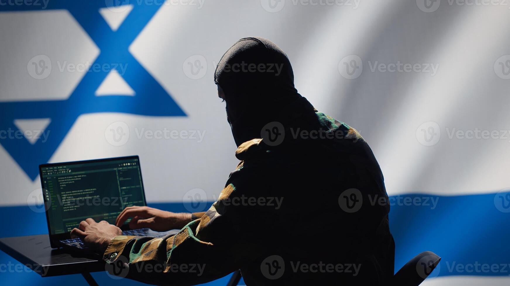 Israel secret police agent uses mass propaganda tools on laptop to influence population minds, engaging in psychological operations. Mossad Israeli spy commits PsyOp sabotage using device, camera A photo