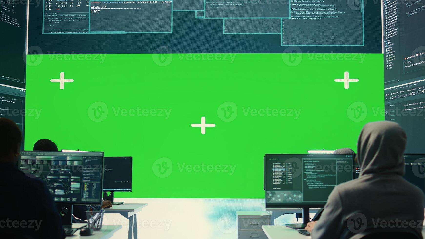 Team of governmental hackers look at green screen in high tech agency office, working together on hacking database systems for cyberwarfare activity. Experts conducting illegal scams. Camera B. photo