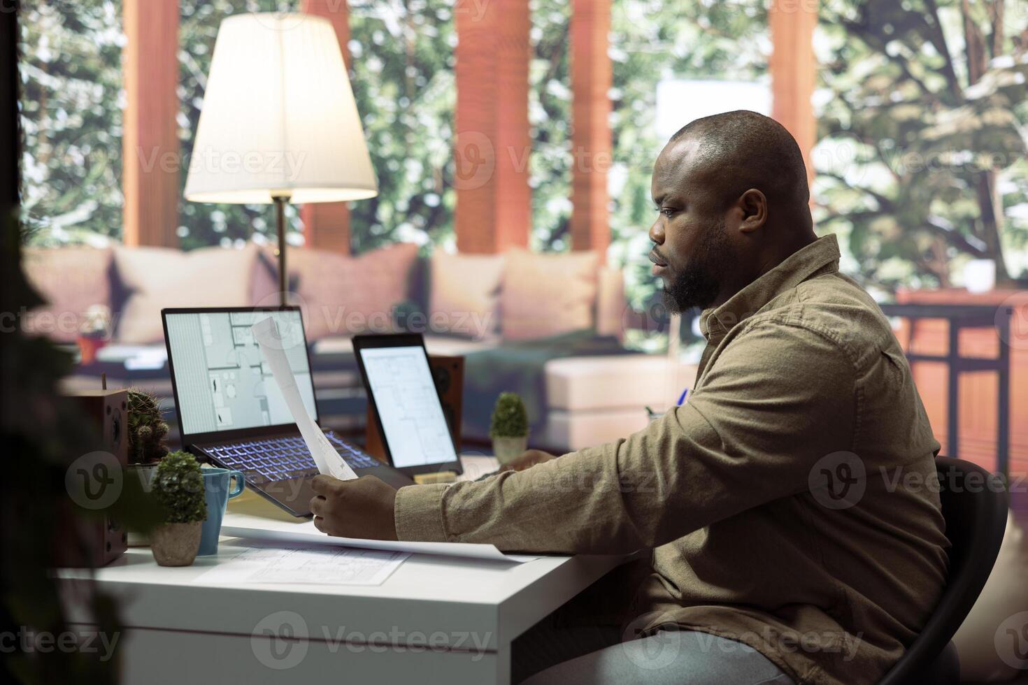 Entrepreneur using digital tools and blueprint drafts to relocate the office space, evaluating architectural sketches for a professional building layout. Hunting for creative workspace. photo