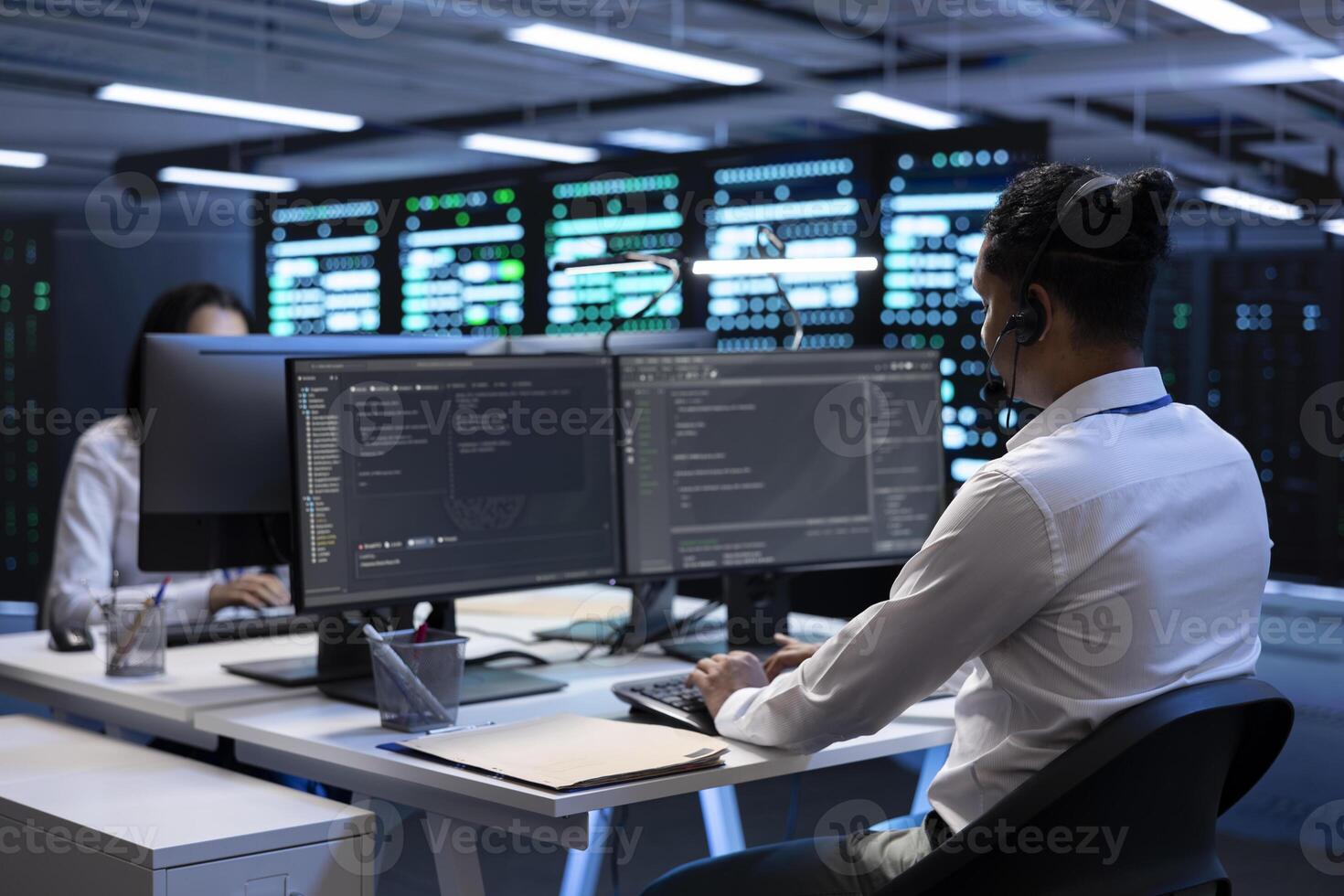 System administrator monitoring and optimizing data center performance and capacity using computer. IT specialist troubleshooting mainframes to ensure optimal performance and minimize downtime photo