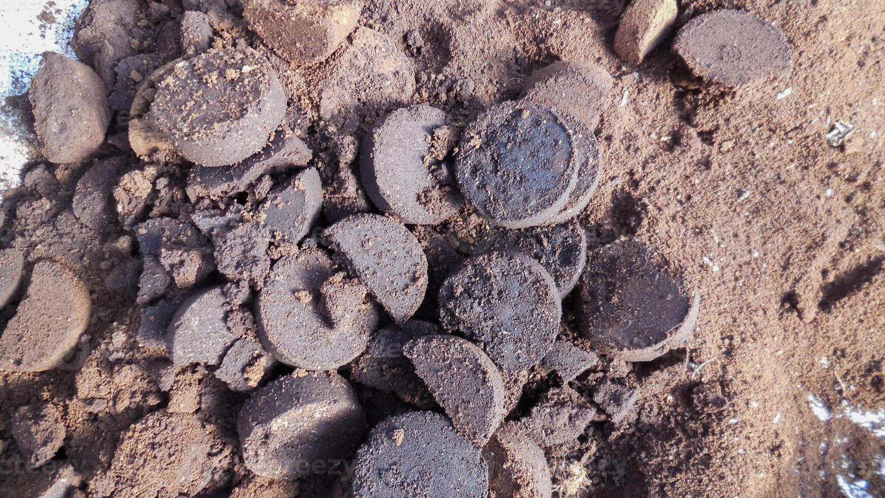 Coffee lumps and grounds are collected in containers after coffee has been crushed and made beverages for customers, collected for use in fertilizing plants, and can also be used to make spa scrubs. photo
