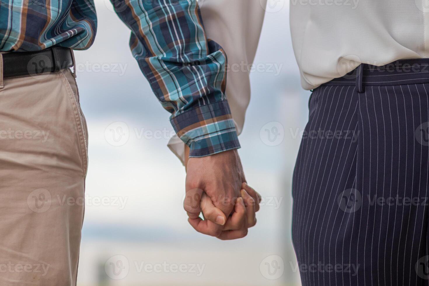 Lovers walk hand in hand to express their love for each other and symbolize love, kindness and beautiful friendship on a blurred background of beautiful scenery on the winter morning. Love concept photo