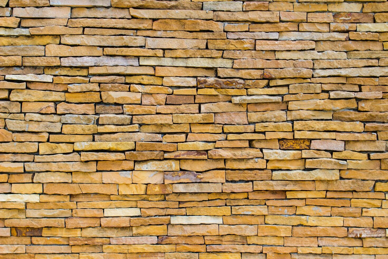 Brick wall background is a wall made of clay bricks, giving the structure strength and cement line between bricks that looks beautiful. It is popular to build a wall of ancient monuments.copy space, photo