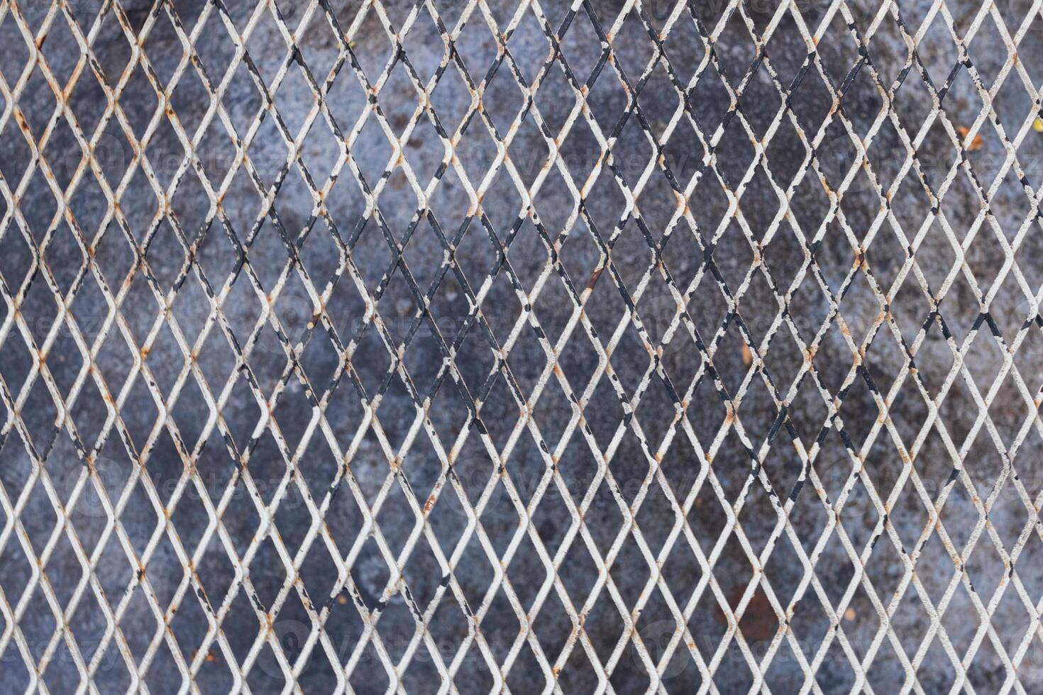 A metal grid background was used to create a high-altitude walking grate as it was lighter than concrete and was visible below. Full frame metal grid backgrounds are perfect for design projects. photo
