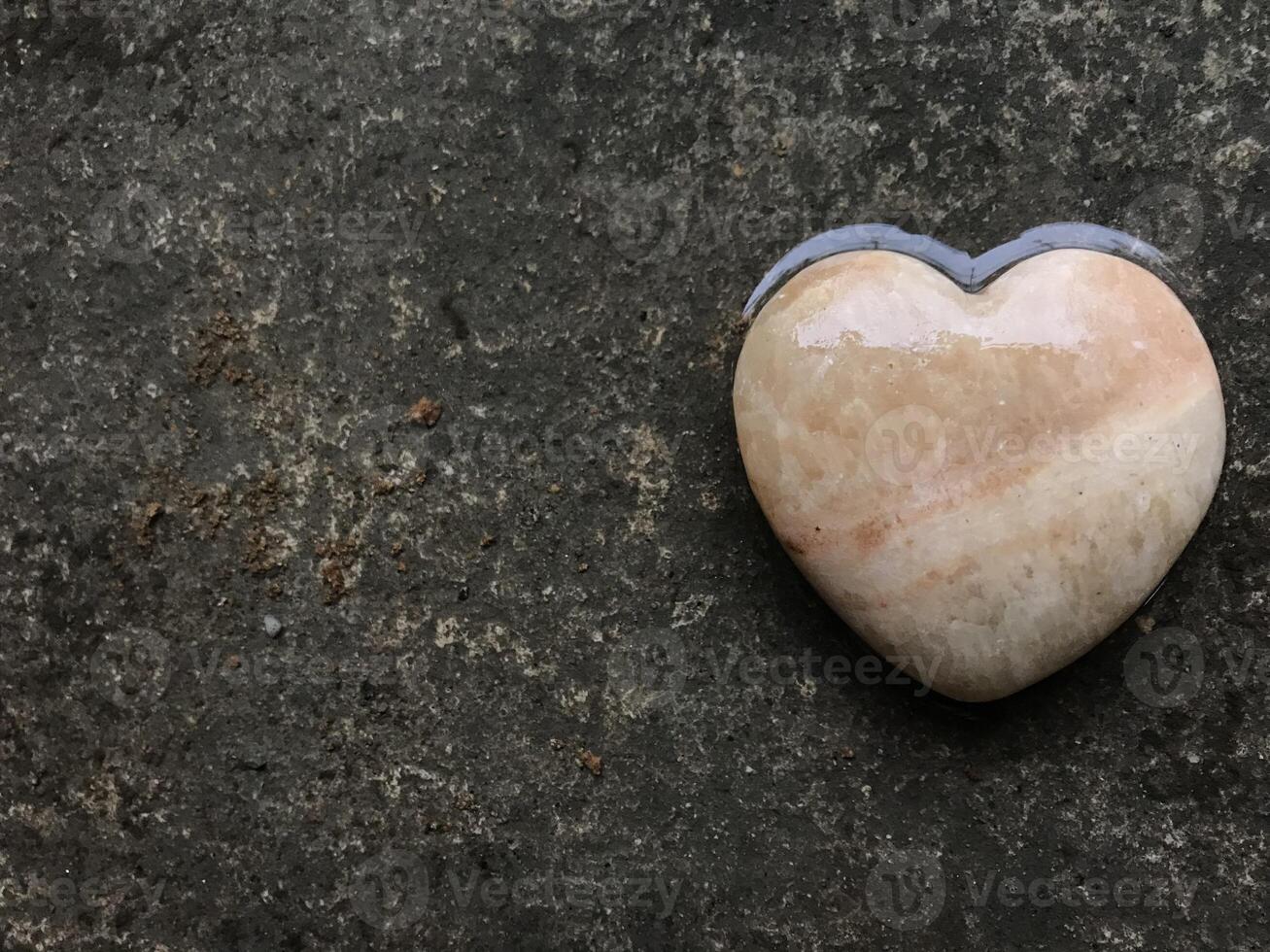 Heart-shaped stones placed on ground symbolize love, friendship and compassion for friends, lovers and family. Friendship, love and kindness concept using heart symbols to represent love. photo
