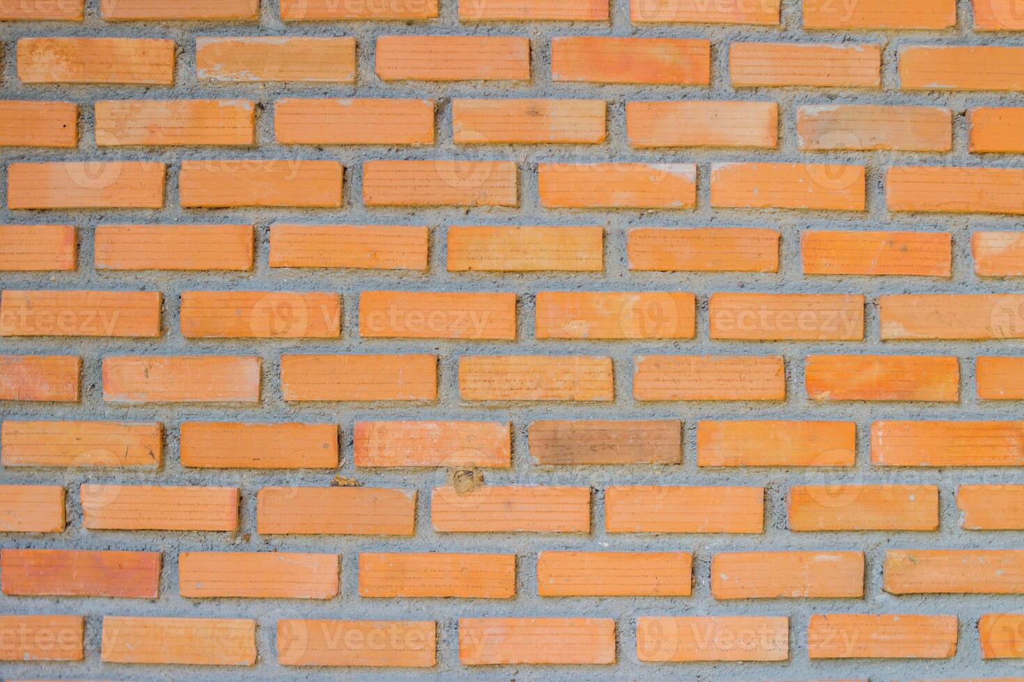 Brick wall background is a wall made of clay bricks, giving the structure strength and cement line between bricks that looks beautiful. It is popular to build a wall of ancient monuments.copy space, photo