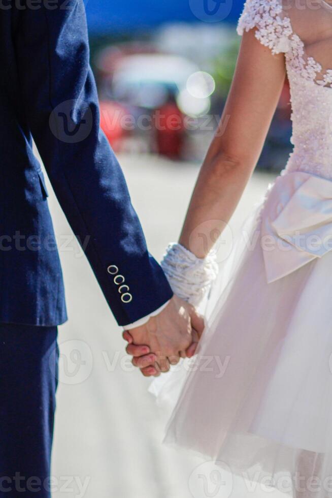 love couple standing lovingly holding hands and admiring beautiful scenery on balcony of their vacation home after happy vacation. concept love couple holding hands means love and care. photo