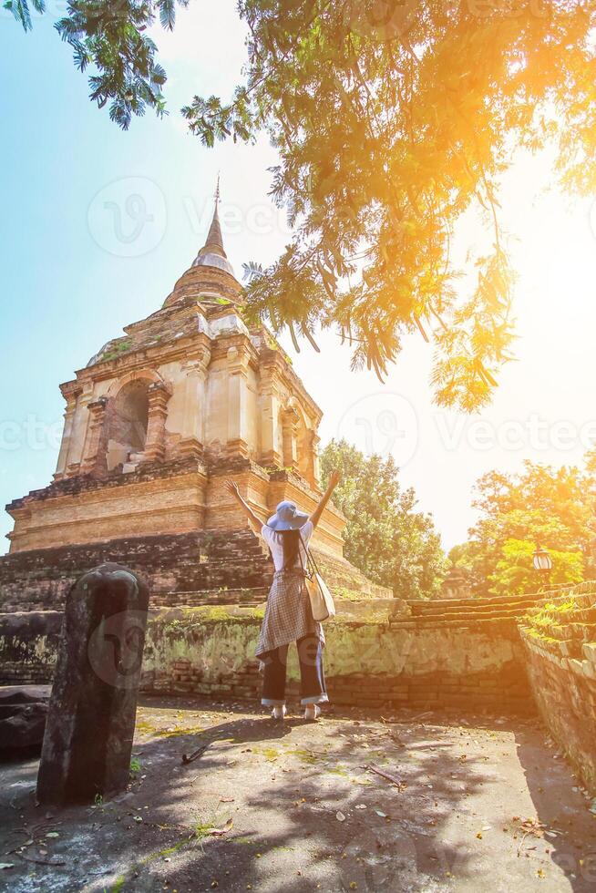 Smooth Focus, A young Asian female tourist is happily walking around Thailand alone admiring the beautiful and unique scenery of Thailand. The concept of traveling alone of tourists in Asia photo