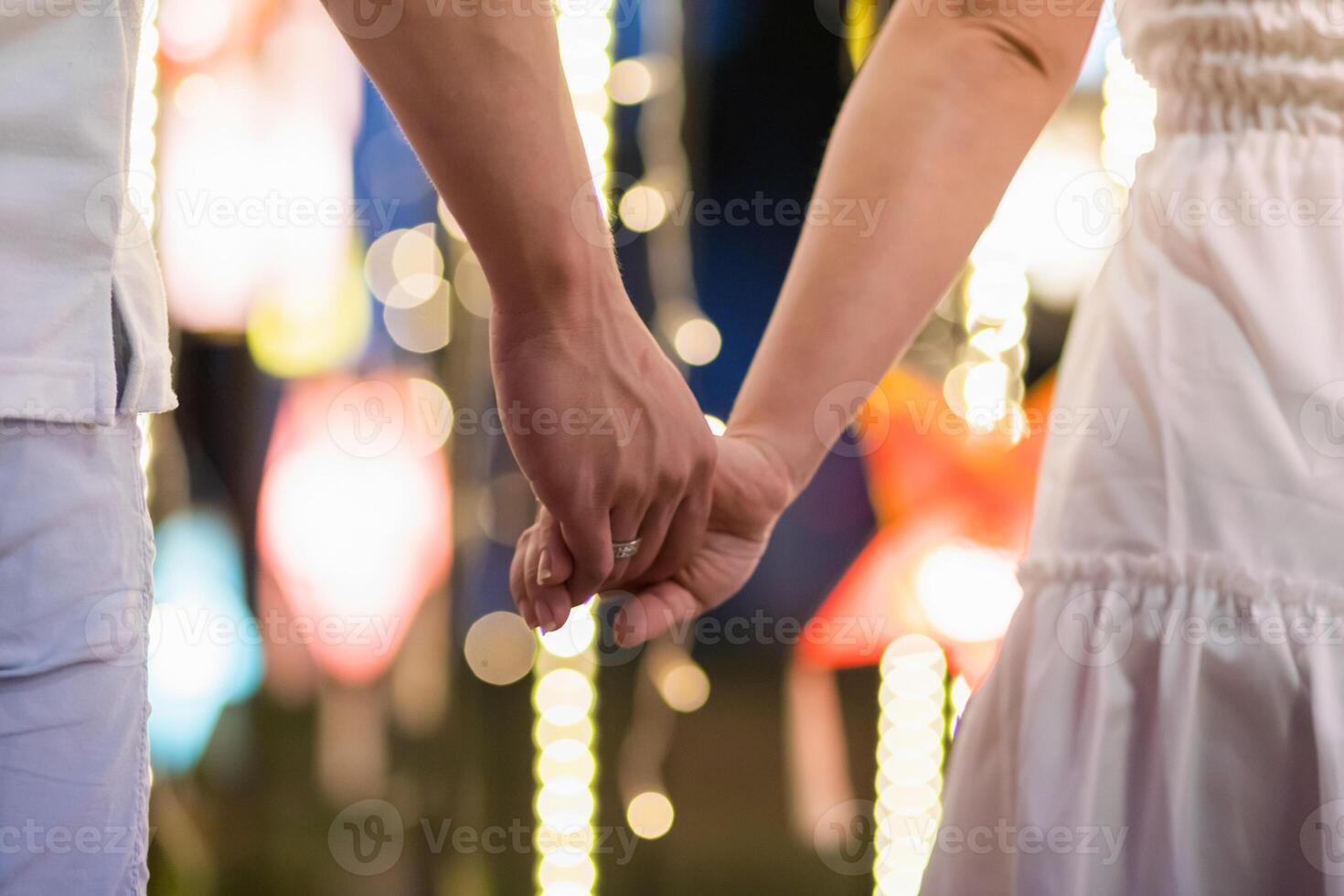 Blur image,couples walking hand in hand along the corridor To see the beautiful scenery of the festive lights happily and her lover wants to say love and propose to her girlfriend on Valentine's Day. photo