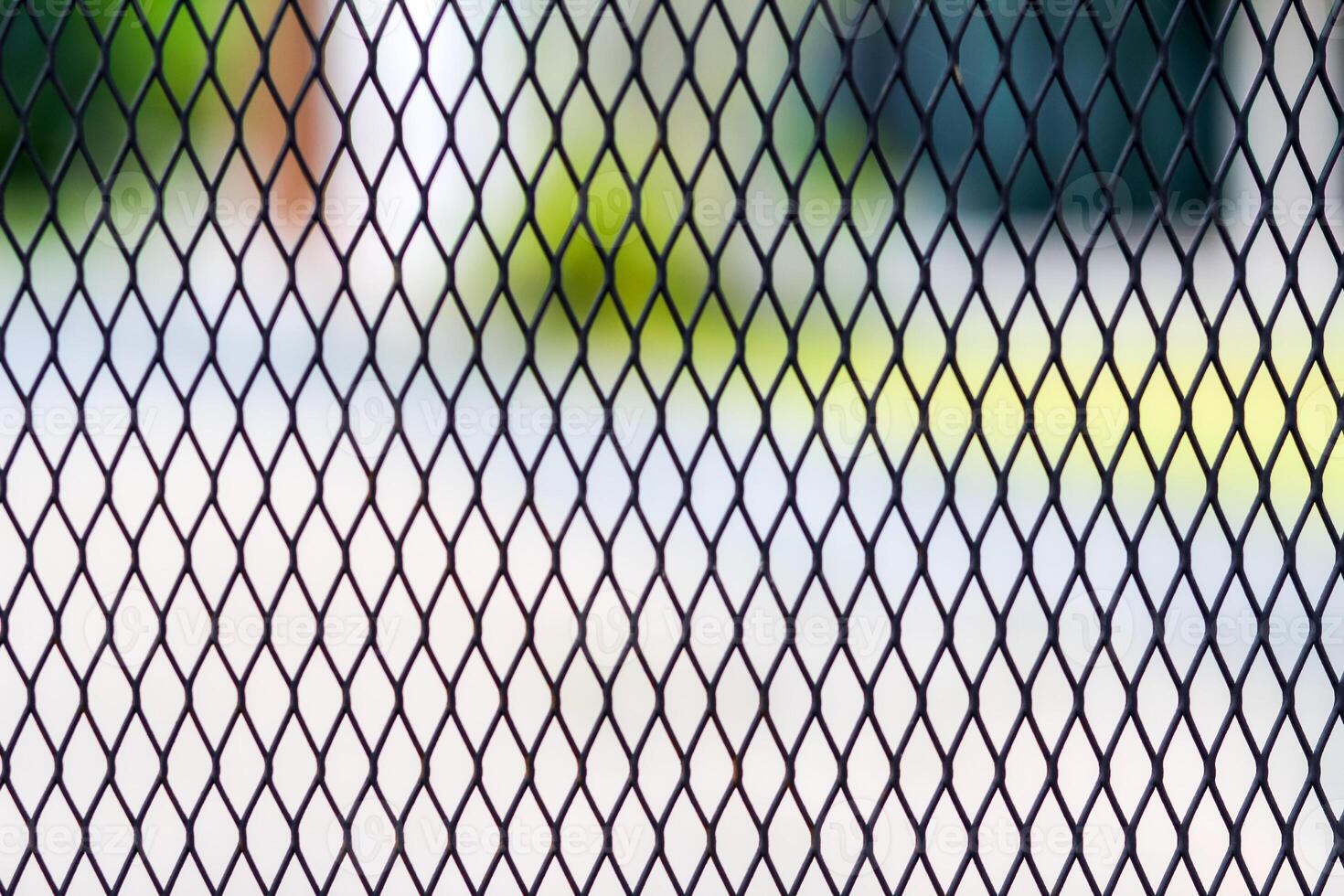A black iron grate is used as a fence to prevent the dangers of people and poisonous animals entering the area. Steel grating background with Copy Space for inserting text for design and advertising. photo