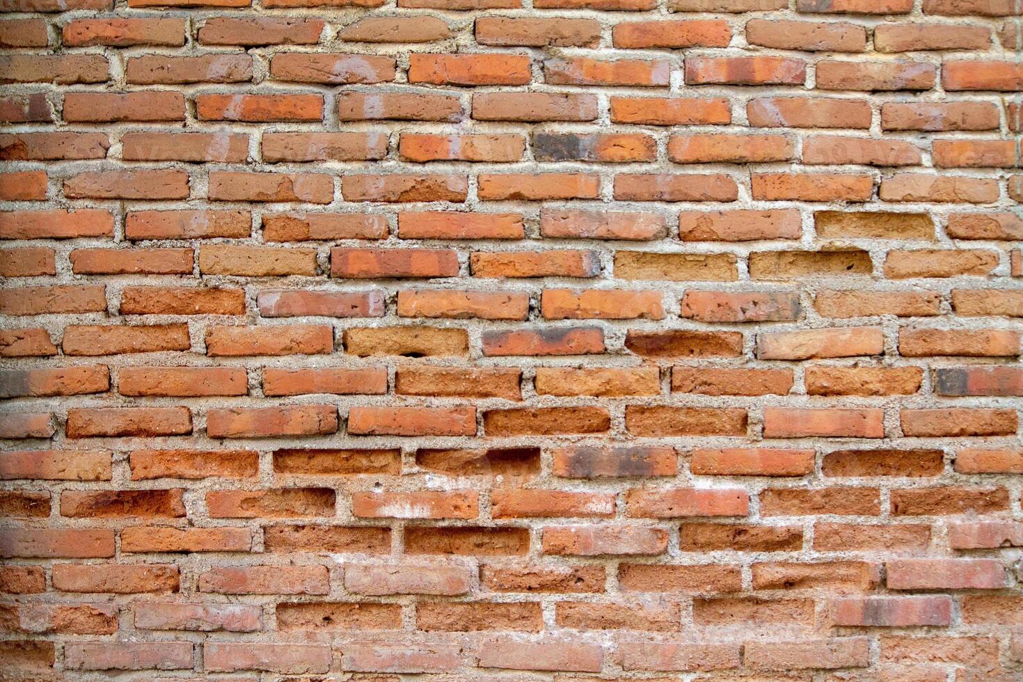 Brick wall background is a wall made of clay bricks, giving the structure strength and cement line between bricks that looks beautiful. It is popular to build a wall of ancient monuments.copy space, photo