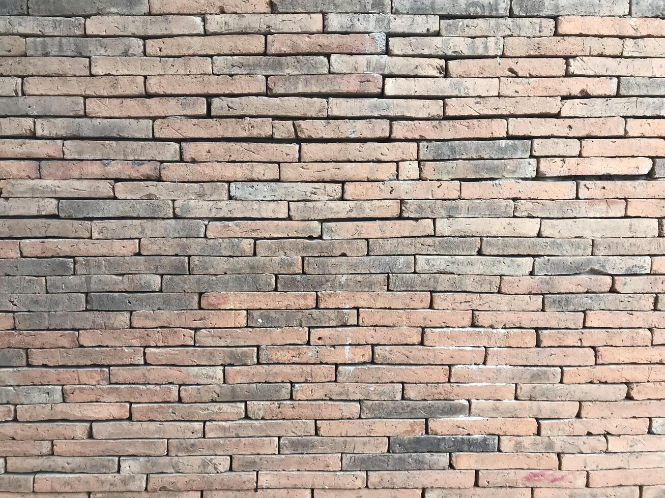 Brick wall background is a wall made of clay bricks, giving the structure strength and cement line between bricks that looks beautiful. It is popular to build a wall of ancient monuments.copy space, photo