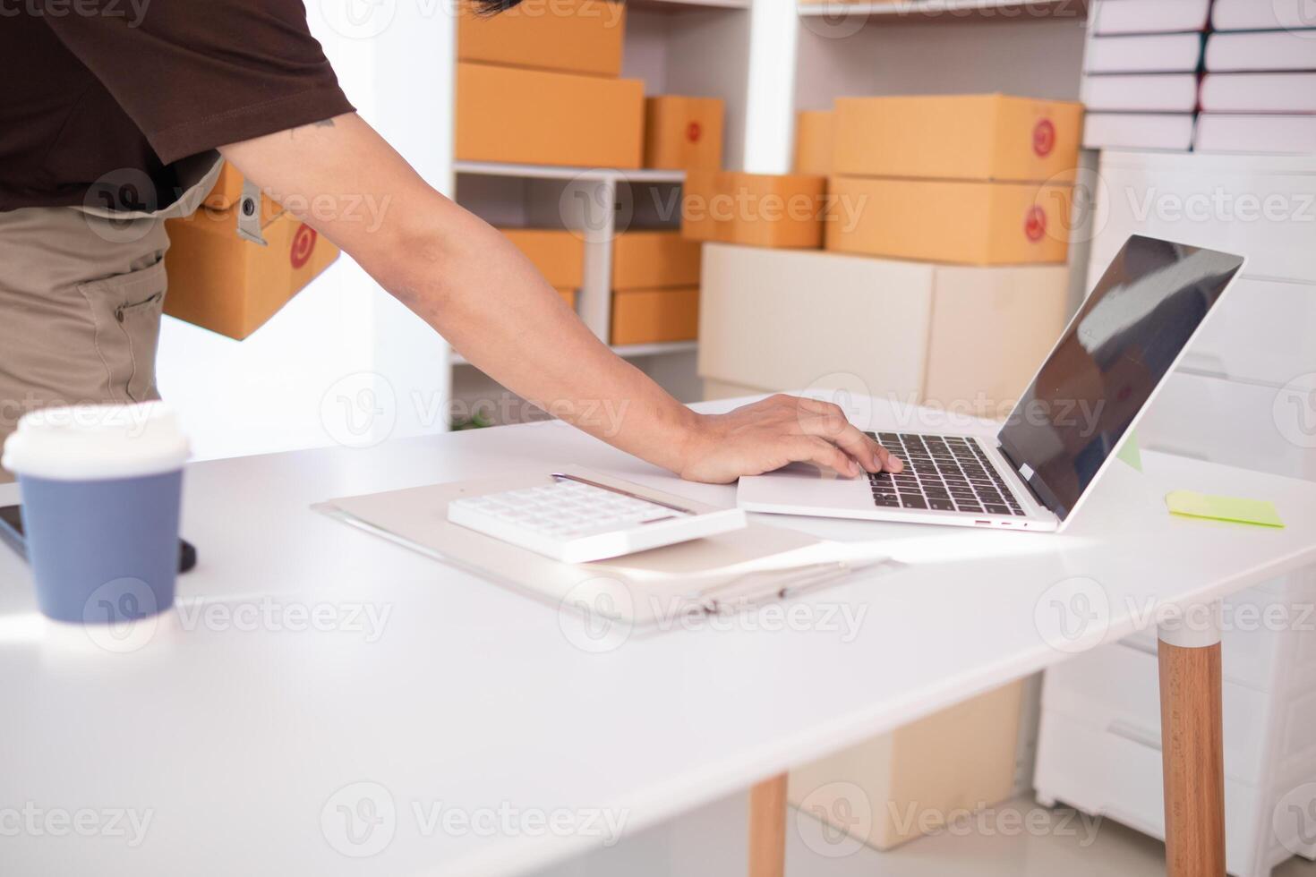 Start Up Business or small SME business owners open an office at home conduct online business and check product stock before sending products according orders customers who order products online. photo