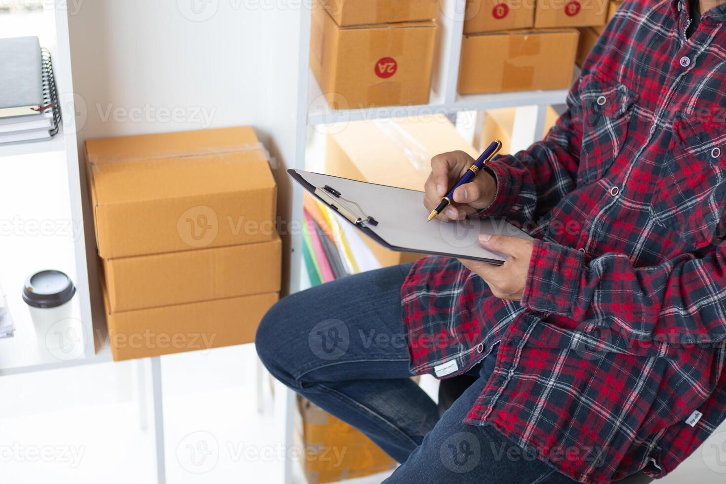 Start Up Business or small SME business owners open an office at home conduct online business and check product stock before sending products according orders customers who order products online. photo