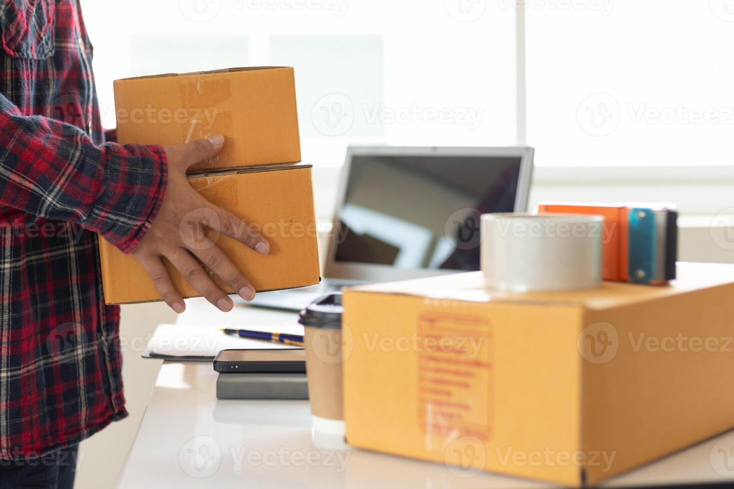 parcel boxes being packaged and ready to be sent to customers who have placed online orders within the online store's system. A small SME businessman has prepared the parcels and is ready for delivery photo