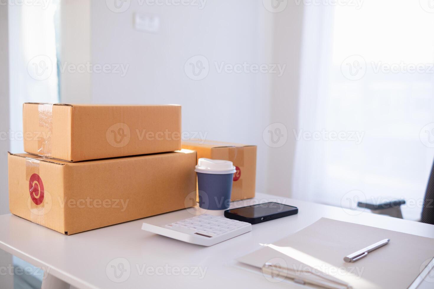 parcel boxes being packaged and ready to be sent to customers who have placed online orders within the online store's system. A small SME businessman has prepared the parcels and is ready for delivery photo