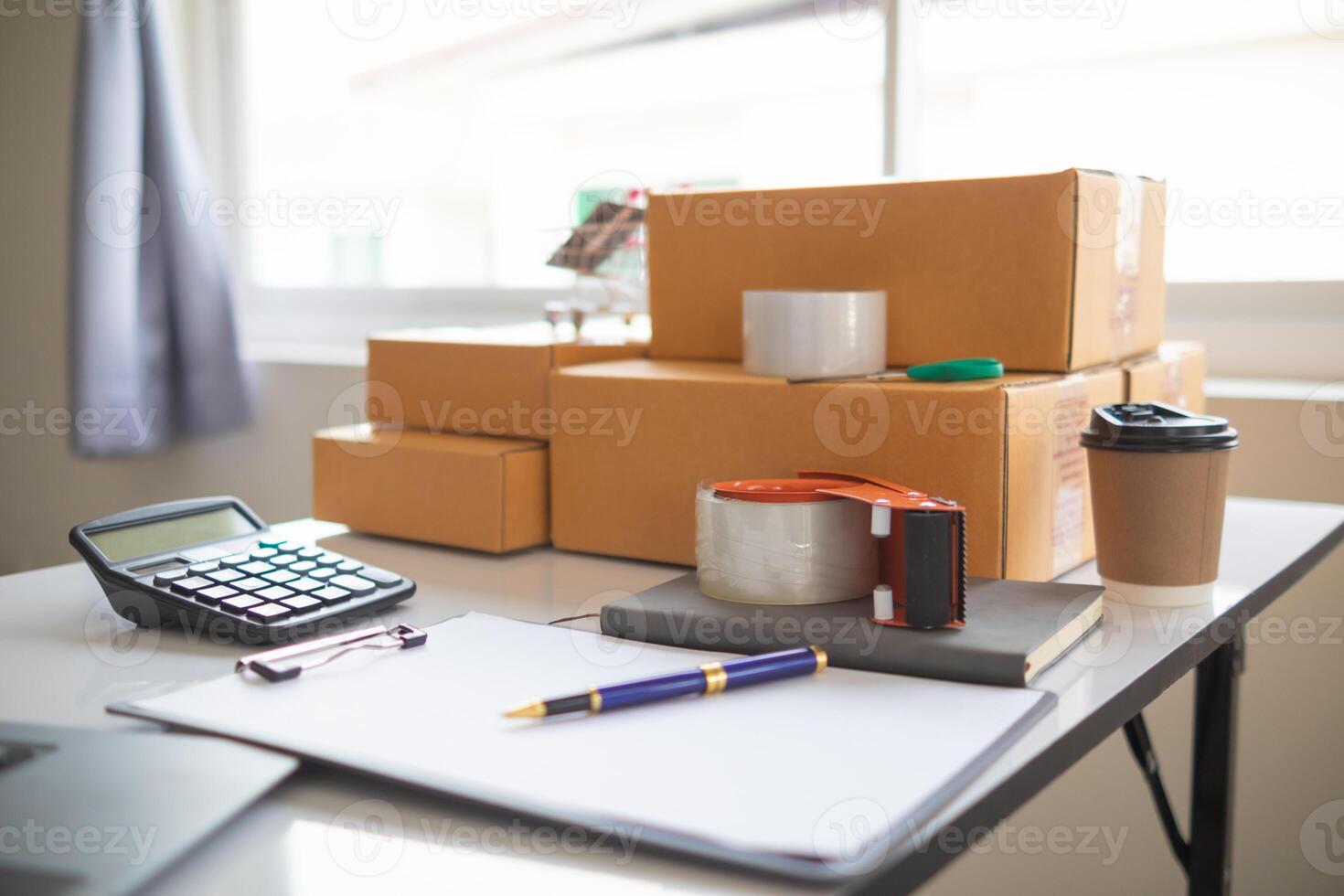 parcel boxes being packaged and ready to be sent to customers who have placed online orders within the online store's system. A small SME businessman has prepared the parcels and is ready for delivery photo