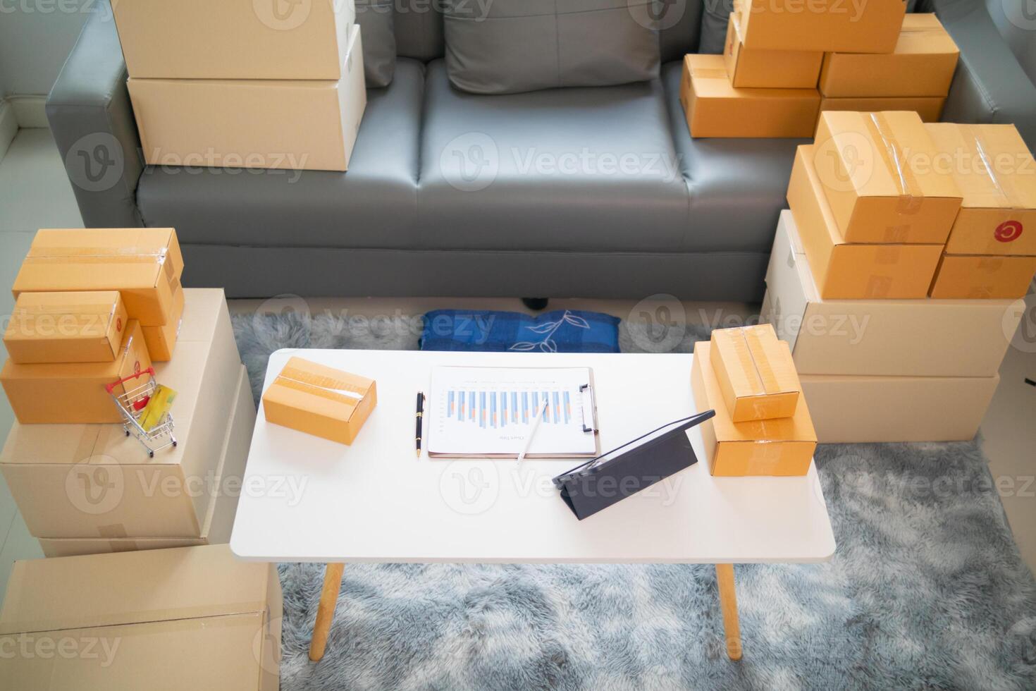 parcel boxes being packaged and ready to be sent to customers who have placed online orders within the online store's system. A small SME businessman has prepared the parcels and is ready for delivery photo