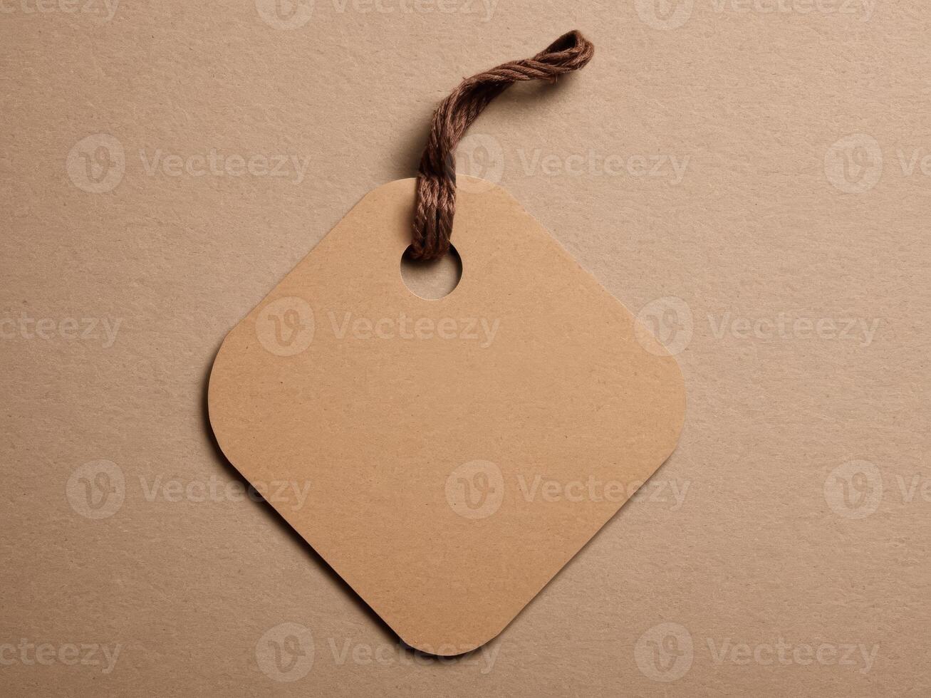 Brown Paper Price Tag With String Isolated on brown background. photo