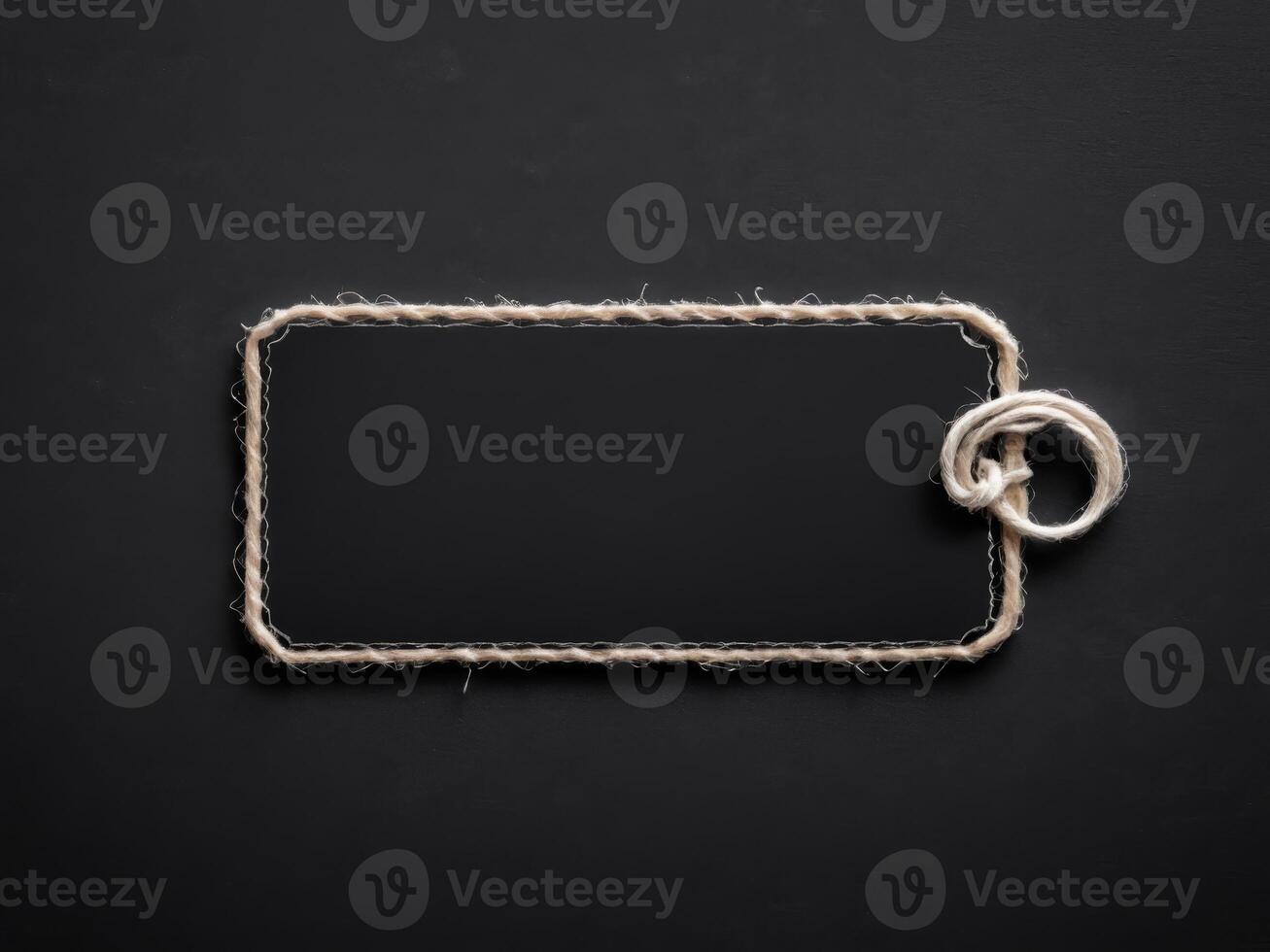 Black Paper Price Label With String Isolated on black background. photo