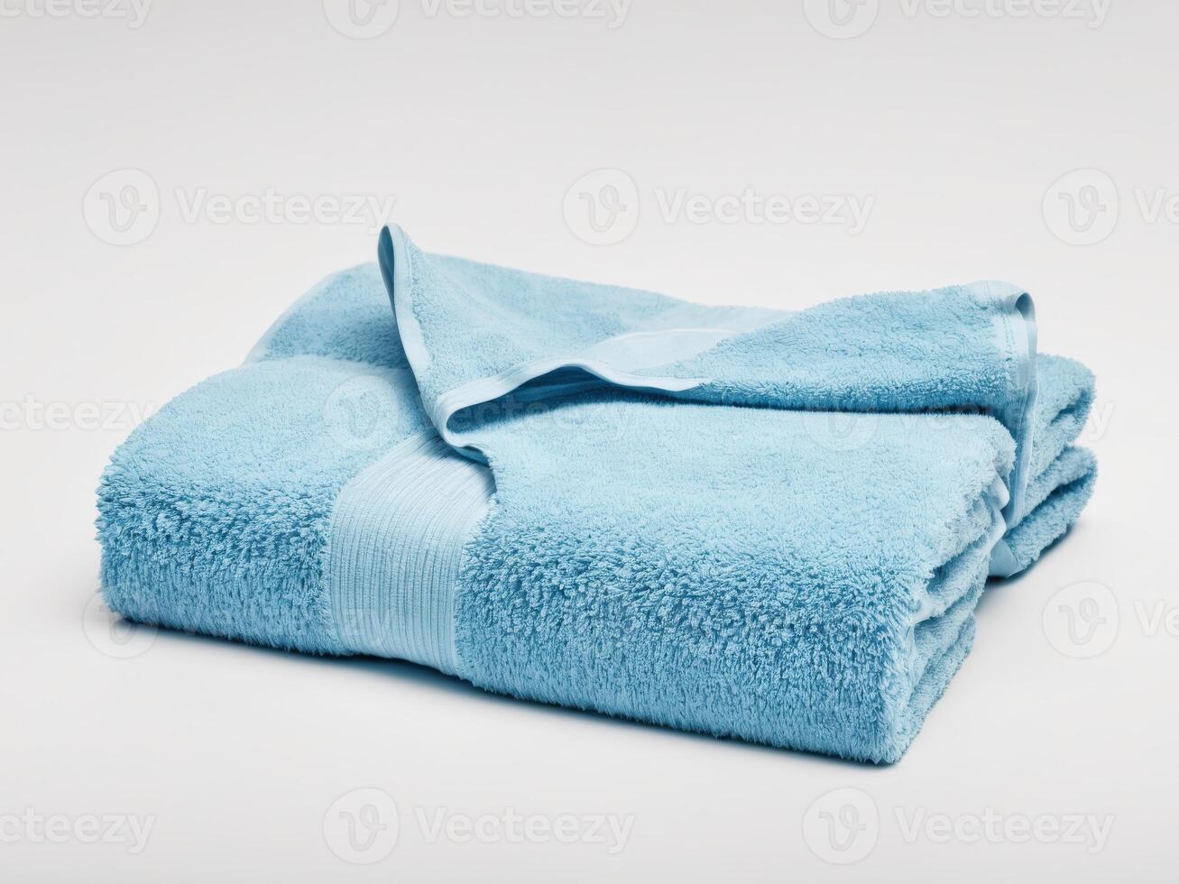 Neatly folded blue towel isolated on white background. photo