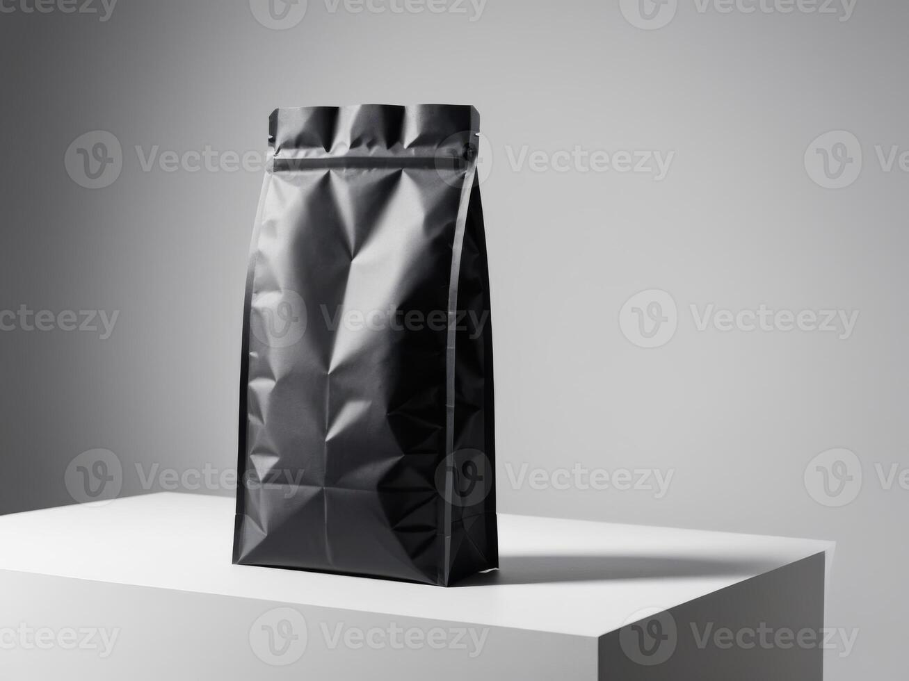 Black paper doypack placed on podium on empty background. photo