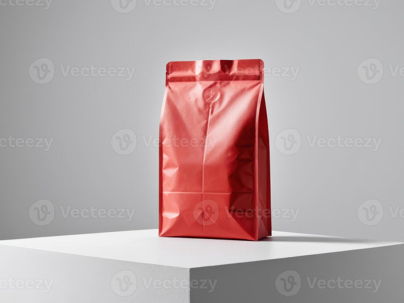 red paper doypack placed on a podium on an empty background. photo