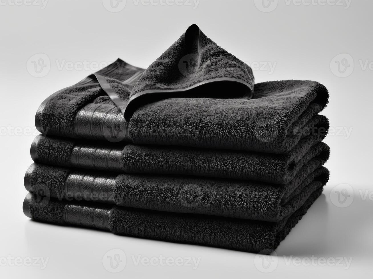 neatly folded black towel isolated on white background. photo