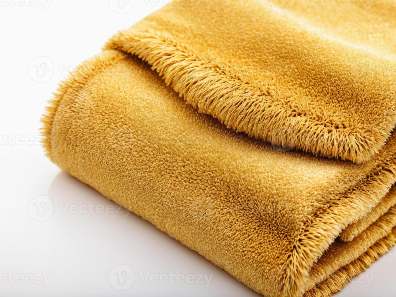 neatly folded golden yellow towel isolated on white background. photo