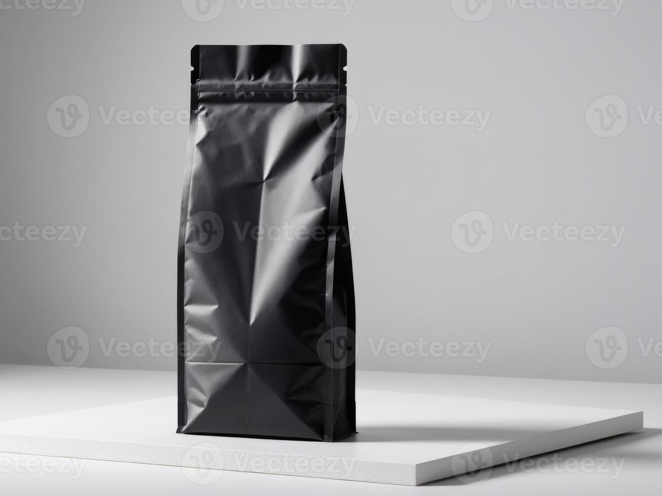 Black paper doypack placed on podium on empty background. photo