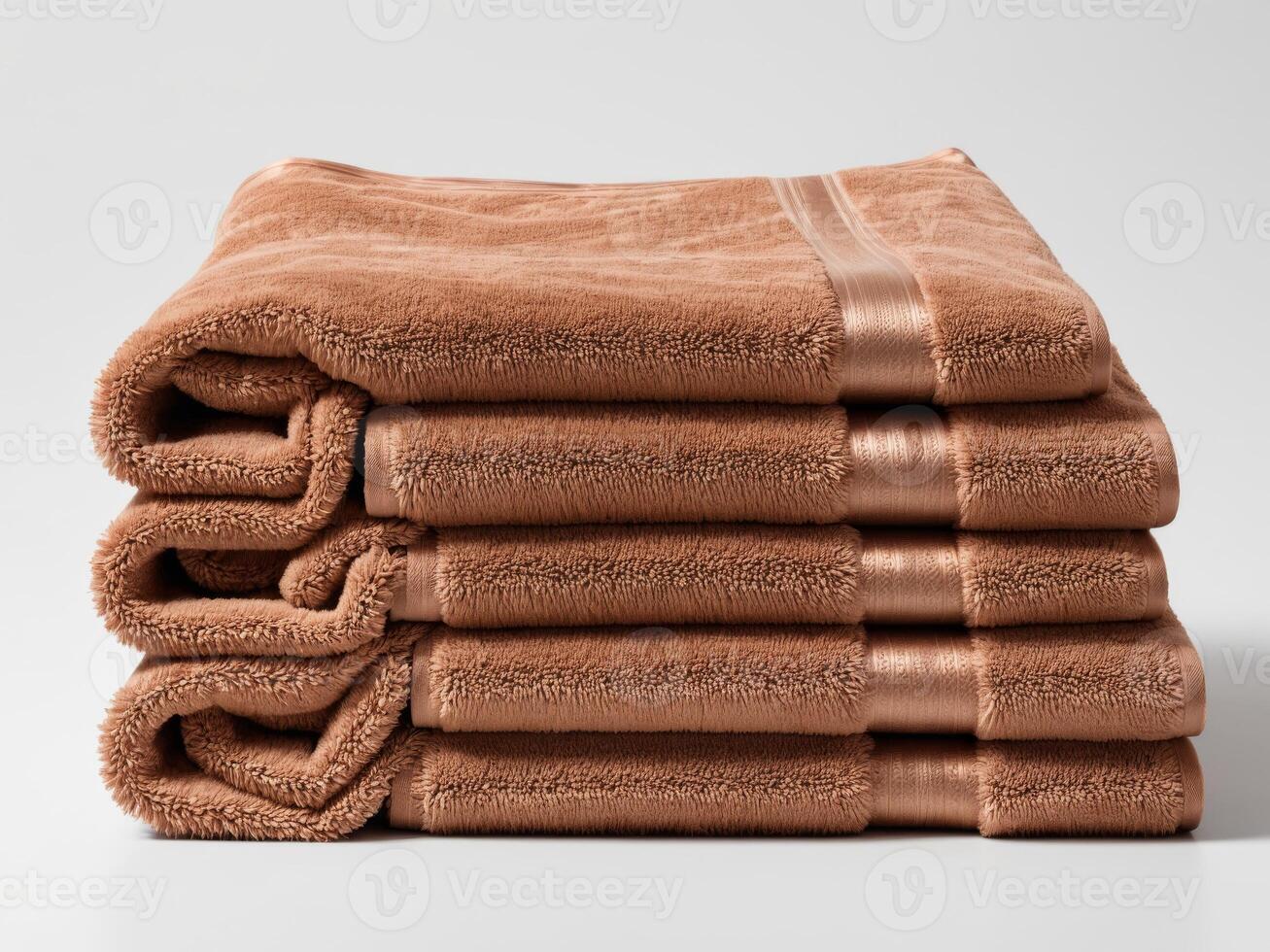Neatly folded bronze brown towel isolated on white background. photo