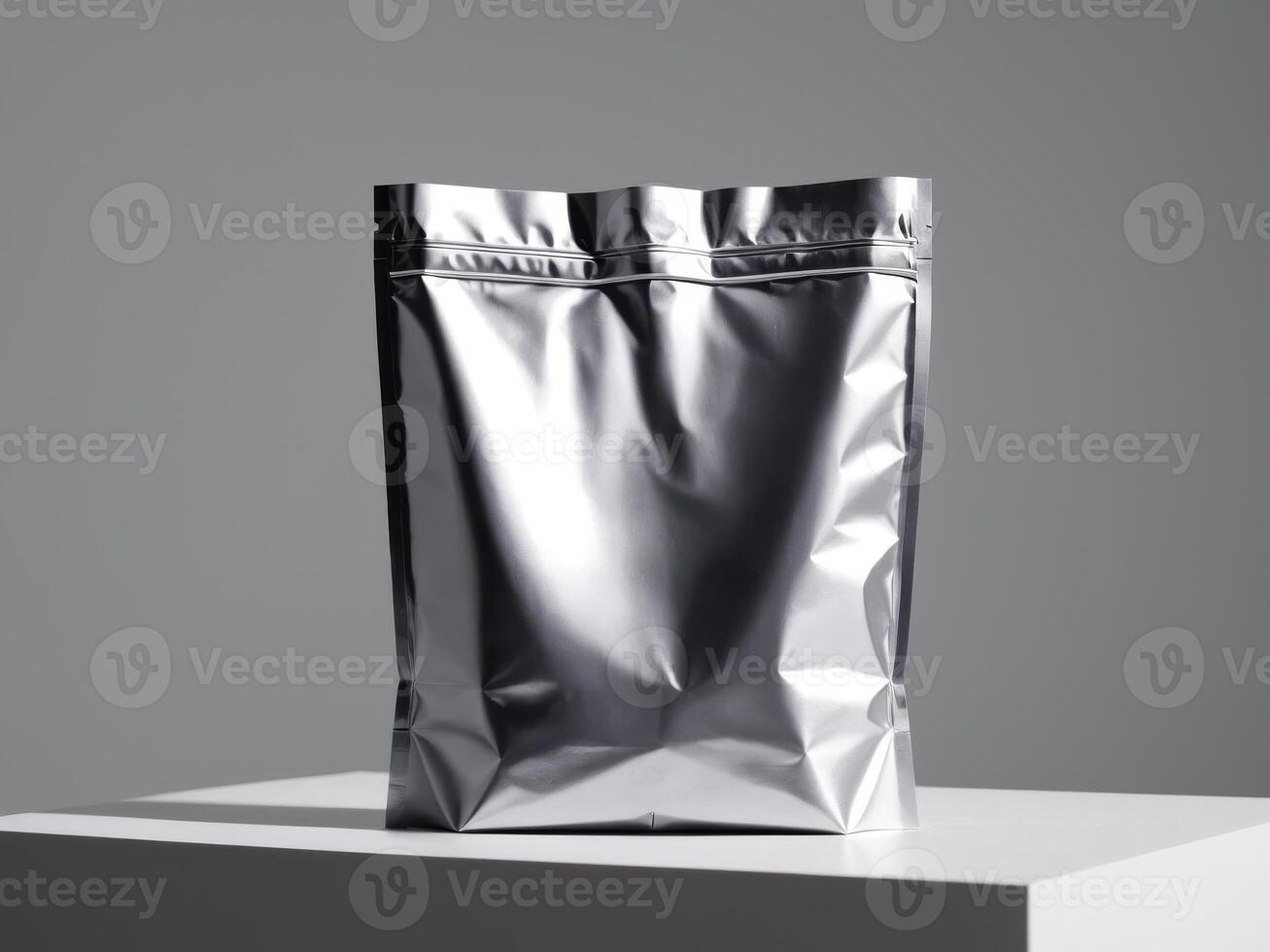 silver paper doypack placed on a podium on a blank background. photo