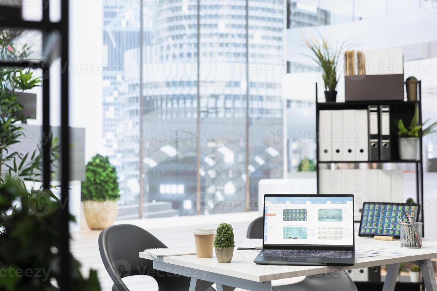 Laptop screen in office showing stock exchange indices changing in real time. Notebook in workspace with forex trading indexes displayed live showing latest price modifications photo