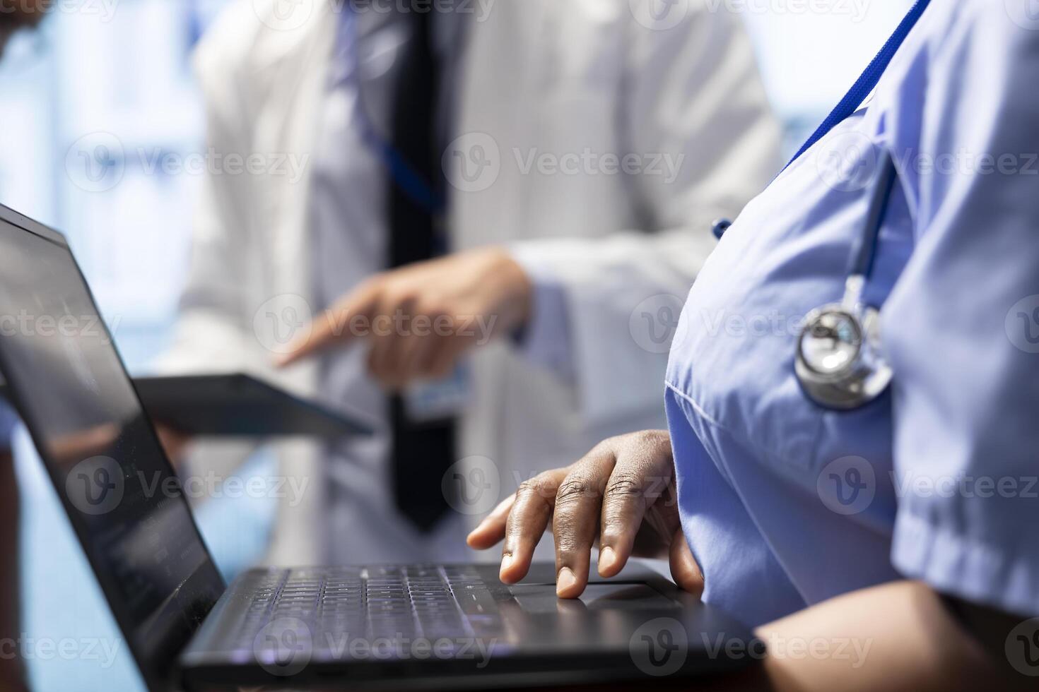 Doctor consulting with his team to examine x ray test results in office, discussing about potential treatment option for a certain disease. Medical staff with radiology expertise. Close up. photo