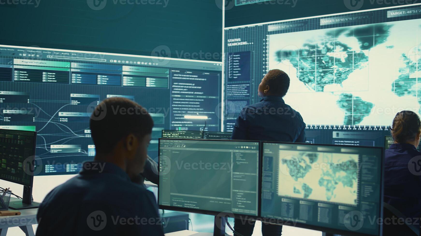 Governmental hackers exploiting network systems in high tech office, executing cyber operations for national server security. Focus on data protection and online safety to combat cybercrime. Camera B. photo