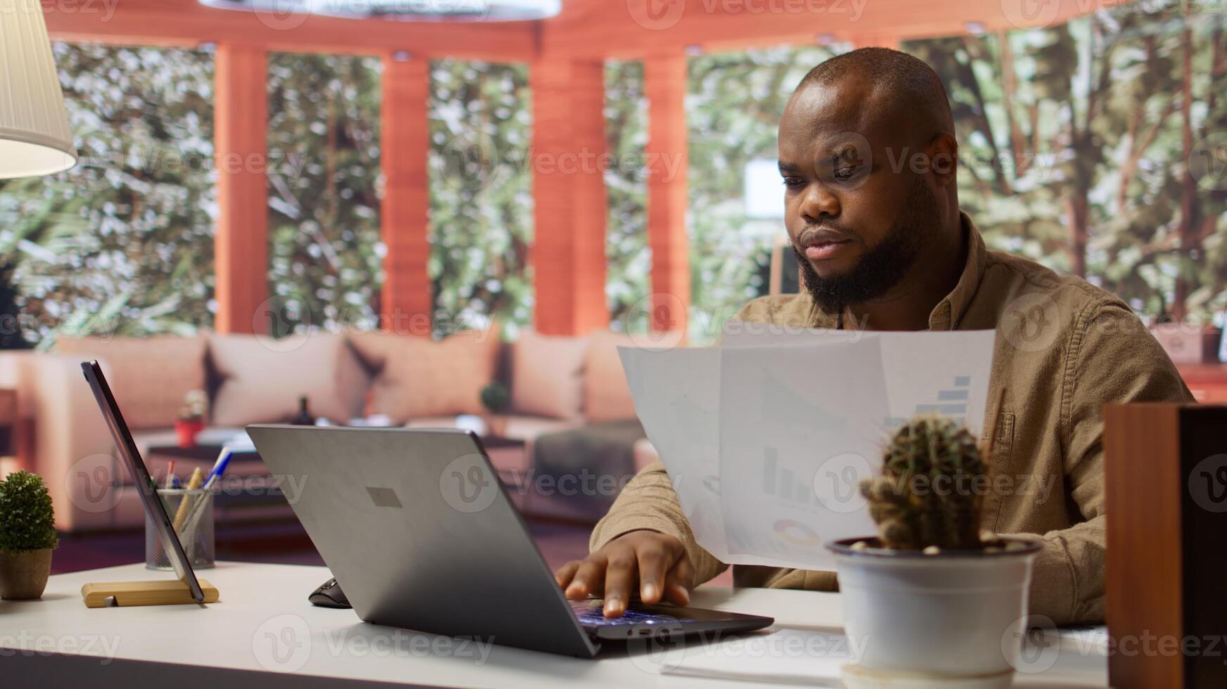 Business owner looks into project development online from home office setup, working on new strategies. Freelancer analyzing data statistics and reports on laptop, telecommuting methods. Camera B. photo