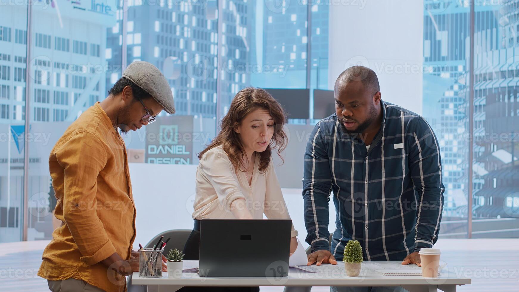 Real estate agent providing layout blueprints to clients in evaluating investment opportunity for leasing a new office space. Business team negotiating with realtor, contract agreement. Camera B. photo
