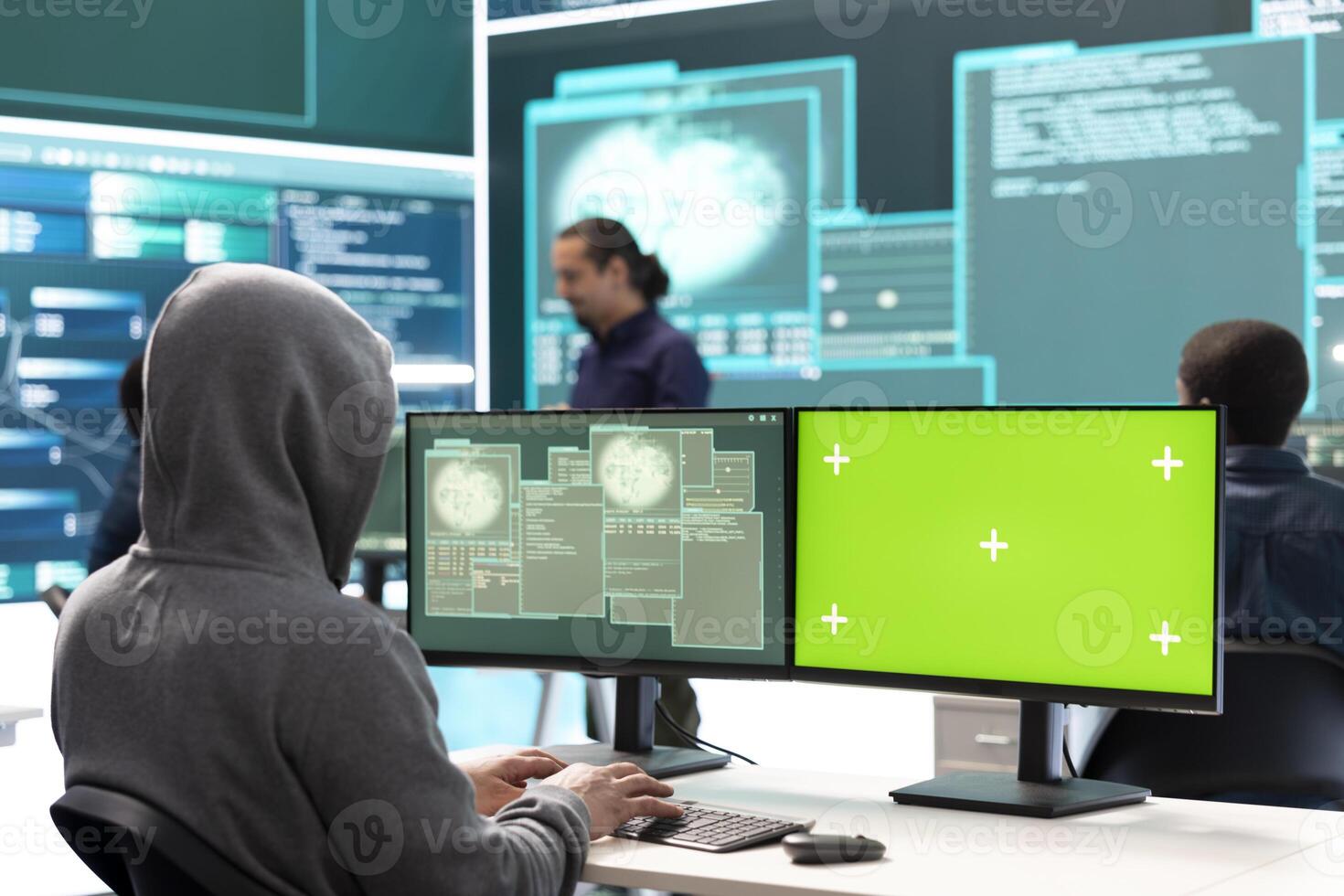 Hacking specialist works with an isolated chroma key display in high tech agency office, securing national servers with state secrets. Governmental hacker examines threat detection measures. photo