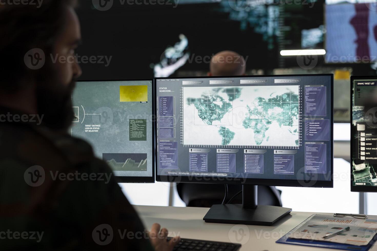 Trooper examines surveillance radar CCTV imagery in control center, monitoring the deployed infantry unit during an ongoing operation. Army conscript works in reconnaissance division. photo